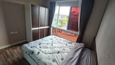 Modern bedroom with large window and stylish decor in urban apartment