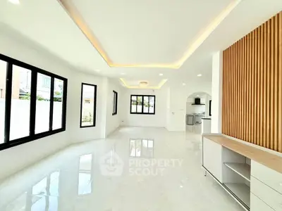 Spacious modern living room with elegant ceiling lights and large windows