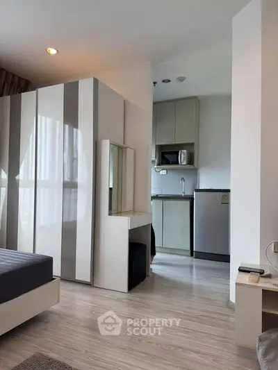 Modern studio apartment with sleek kitchen and stylish furnishings