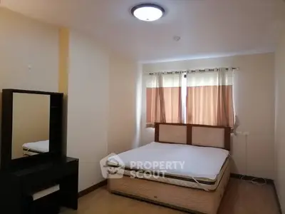 Cozy bedroom with natural light and modern furnishings, perfect for relaxation and comfort.