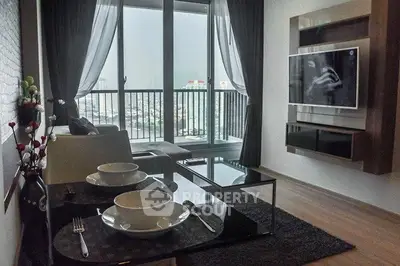 Modern living room with large windows and city view, featuring sleek furniture and wall-mounted TV.