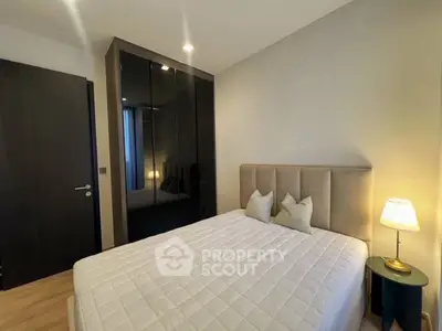 Modern bedroom with sleek wardrobe and cozy lighting