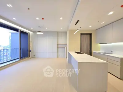 Spacious modern kitchen with open layout and city view balcony