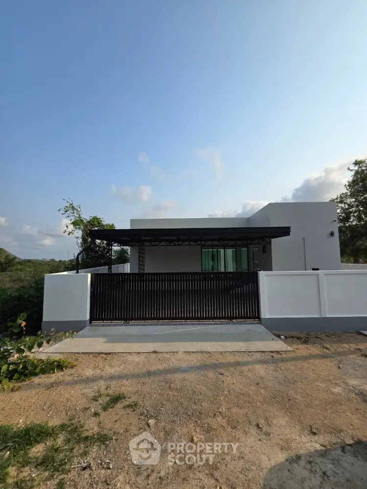 Modern minimalist house exterior with sleek design and spacious front yard