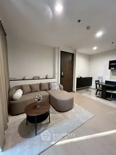 Modern living room with cozy sofa and stylish decor in a contemporary apartment.