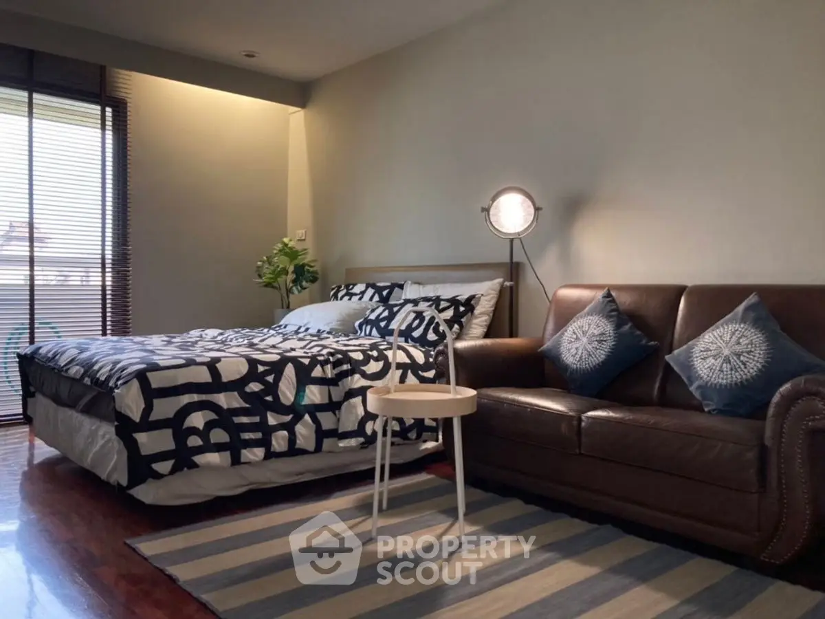 Cozy bedroom with stylish decor and comfortable seating area