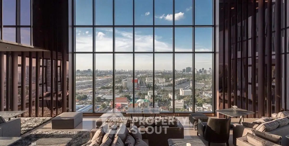 Luxurious living room with panoramic city view through floor-to-ceiling windows.