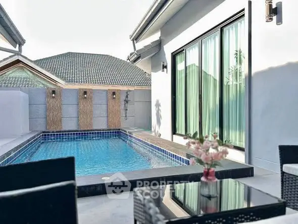 Luxurious private pool area with modern patio furniture and elegant design.