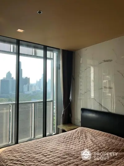 Modern bedroom with city view and large windows in high-rise apartment