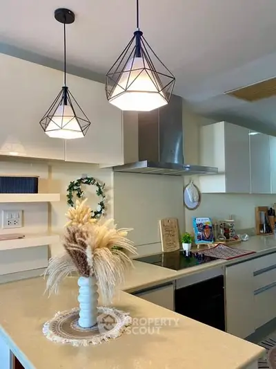 Modern kitchen with stylish pendant lights and elegant decor