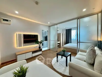 Modern open-plan living room with stylish decor and cozy bedroom view