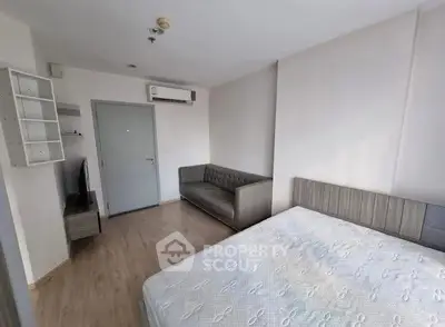 Modern bedroom with minimalist decor and air conditioning in a bright apartment.