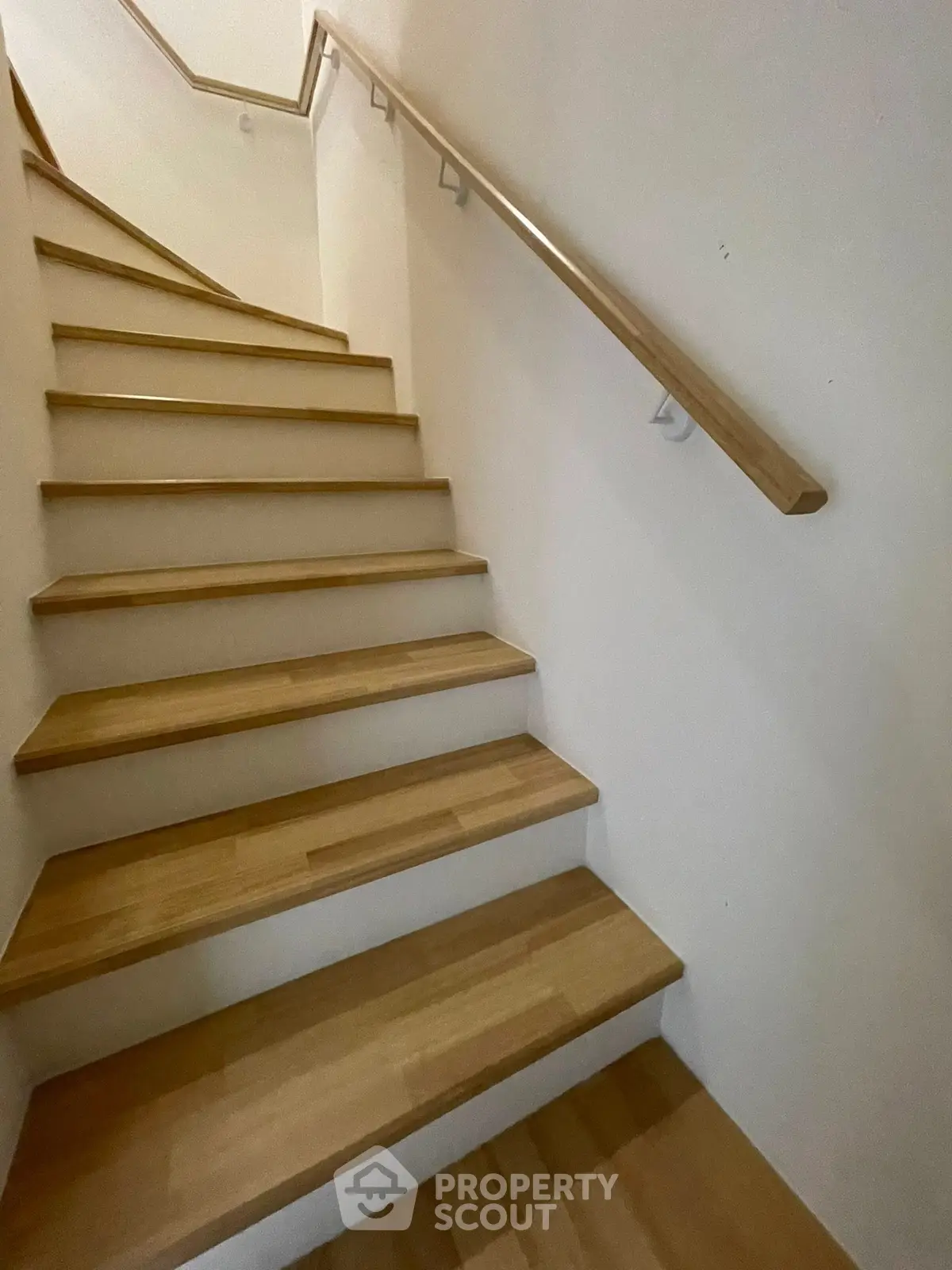 Elegant wooden staircase with sleek handrail in modern home