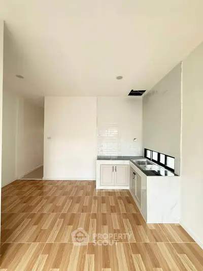 Modern kitchen with sleek cabinetry and tiled flooring in a bright, open space.