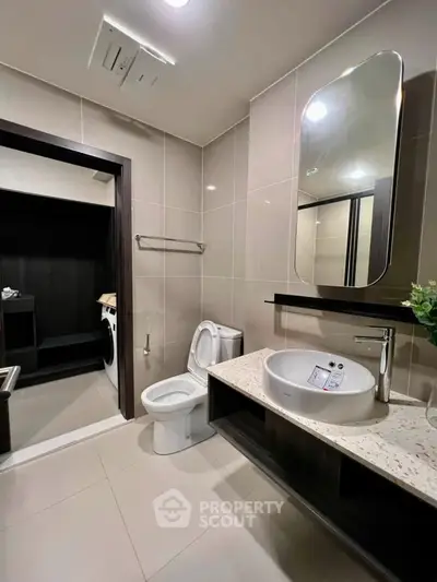 Modern bathroom with sleek fixtures and spacious design in a contemporary apartment.