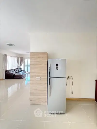 Spacious modern living room with sleek fridge and elegant tile flooring