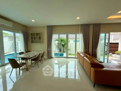 Spacious living room with pool view and modern furniture