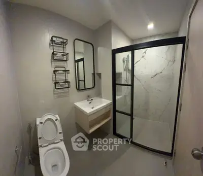 Modern bathroom with sleek fixtures and spacious shower area