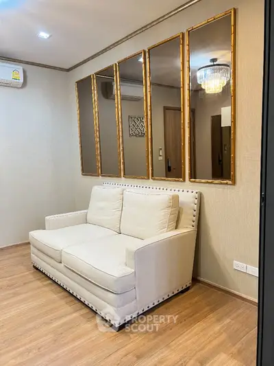 Elegant living room with plush sofa and mirrored wall accents