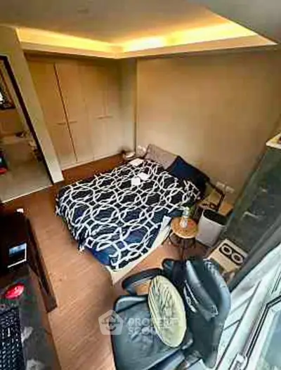 Cozy bedroom with modern decor and ample natural light, featuring a comfortable bed and stylish furnishings.