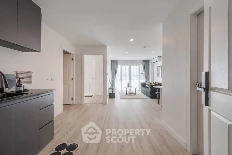 Spacious modern apartment with open layout and stylish decor, featuring a sleek kitchen and inviting living area.