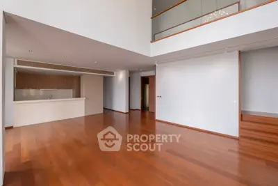 Spacious modern living room with high ceilings and wooden flooring