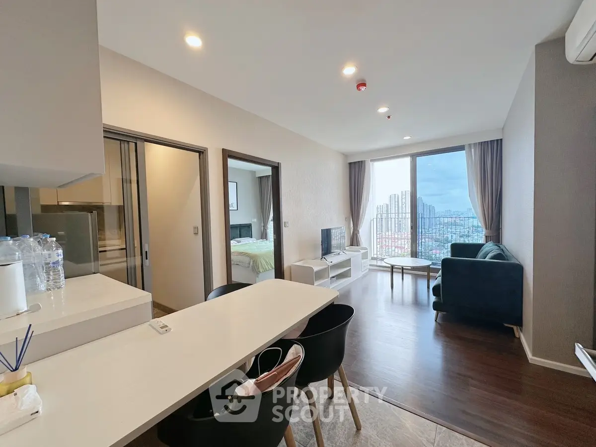Modern open-plan living room with city view and stylish furnishings