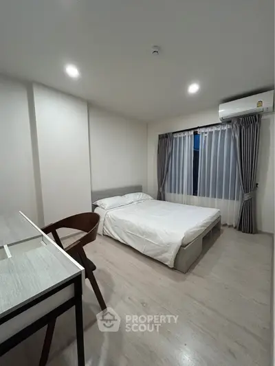 Modern minimalist bedroom with sleek furniture and natural light