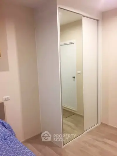 Modern bedroom with mirrored wardrobe and minimalist design