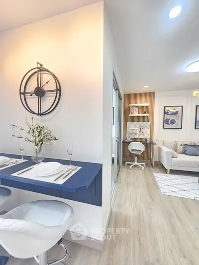 Modern open-concept living space with stylish decor and cozy seating area.