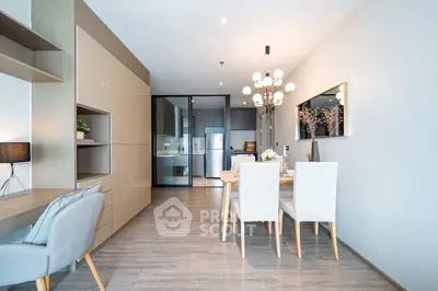 Modern dining area with elegant chandelier and open kitchen layout