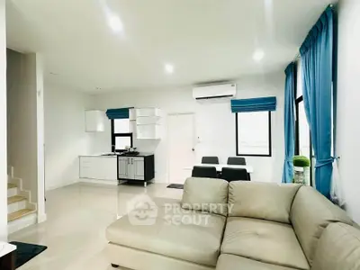 Spacious modern living room with open kitchen and elegant decor