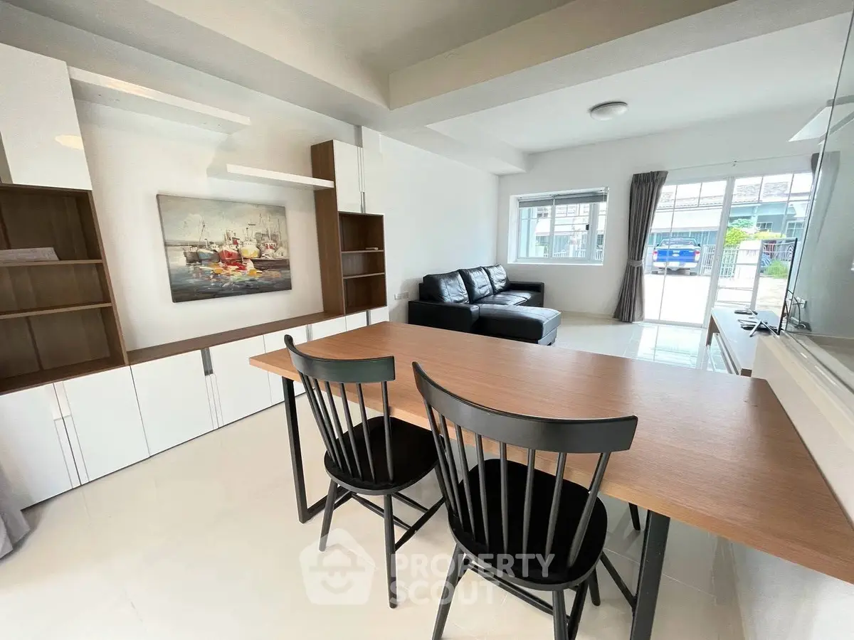 Spacious modern living room with sleek furniture and large windows for natural light.