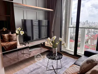 Modern living room with city view, stylish decor, and large TV, perfect for urban living.