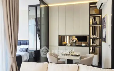 Modern open-plan living room with elegant dining area and cozy bedroom view.