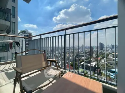 Stunning high-rise balcony with panoramic city views and modern outdoor seating.