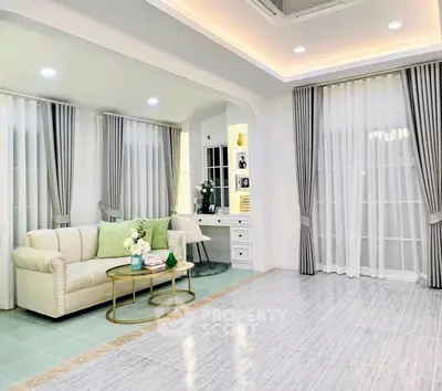 Elegant living room with modern decor and large windows