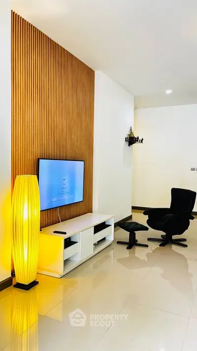 Modern living room with sleek TV setup and stylish lighting