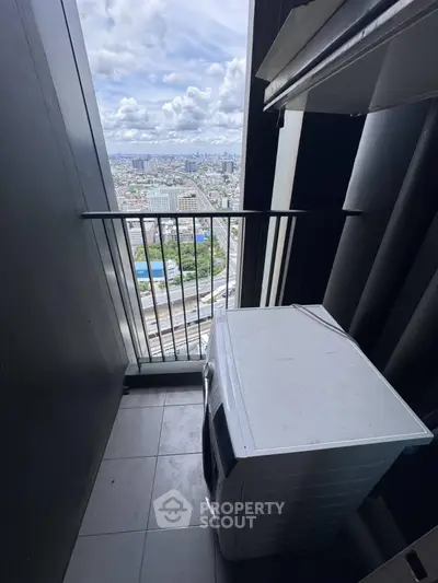 High-rise balcony with washing machine and panoramic city view.