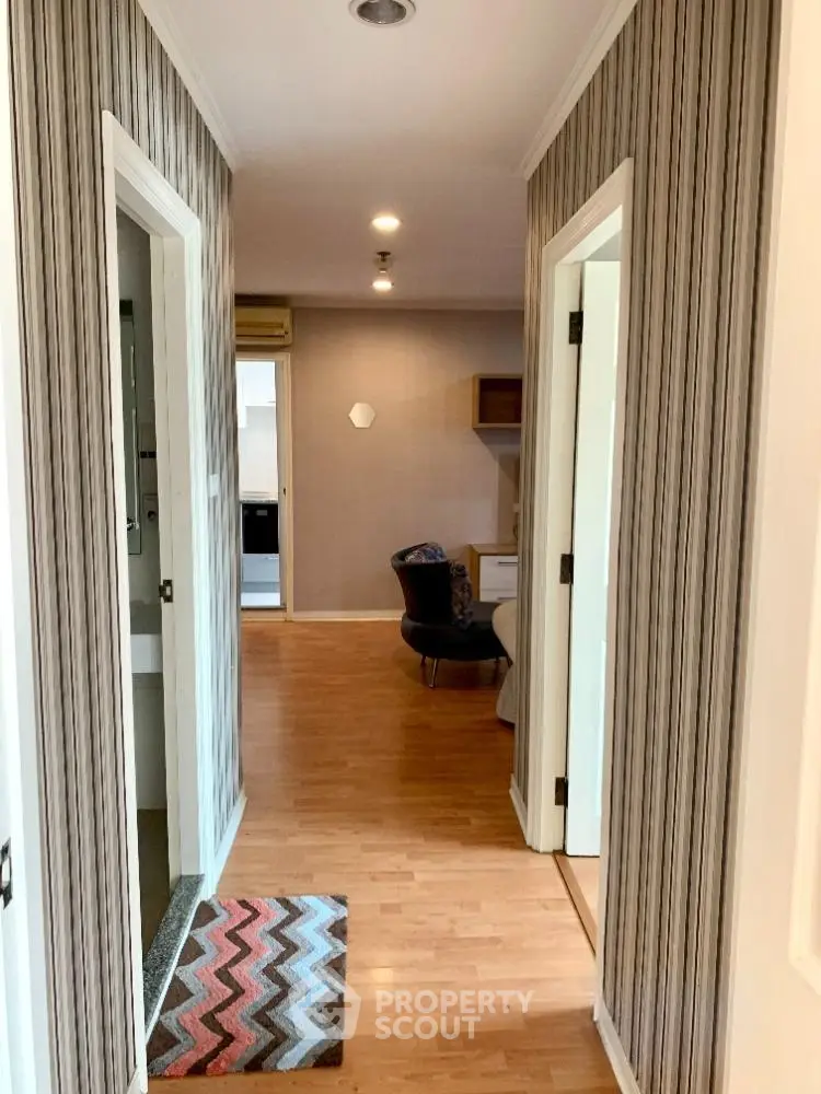 Stylish hallway with modern decor and wooden flooring in a contemporary apartment.