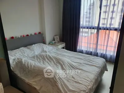 Cozy bedroom with large window and modern decor in urban apartment