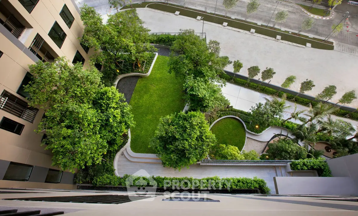 Stunning aerial view of a lush garden in a modern building complex.