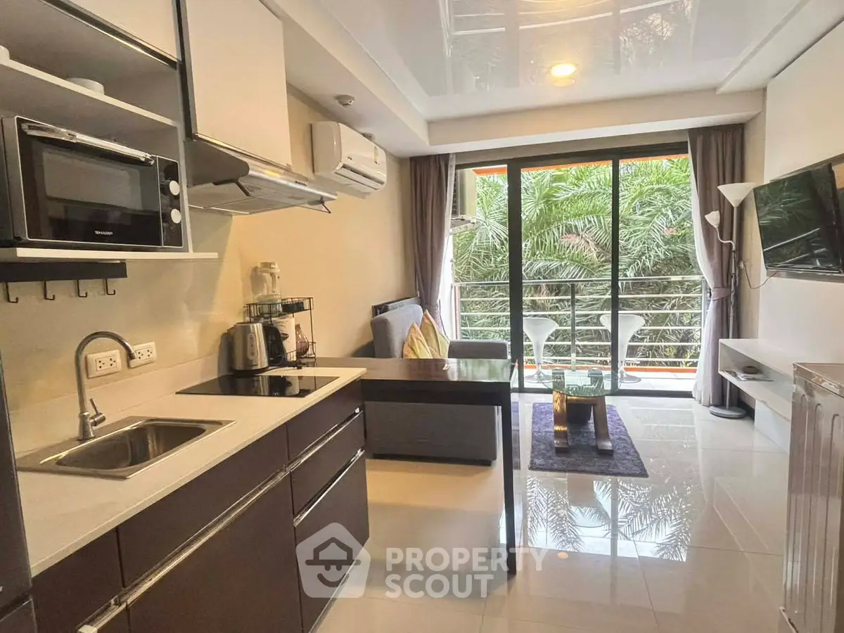Modern open-layout kitchen and living room with balcony view