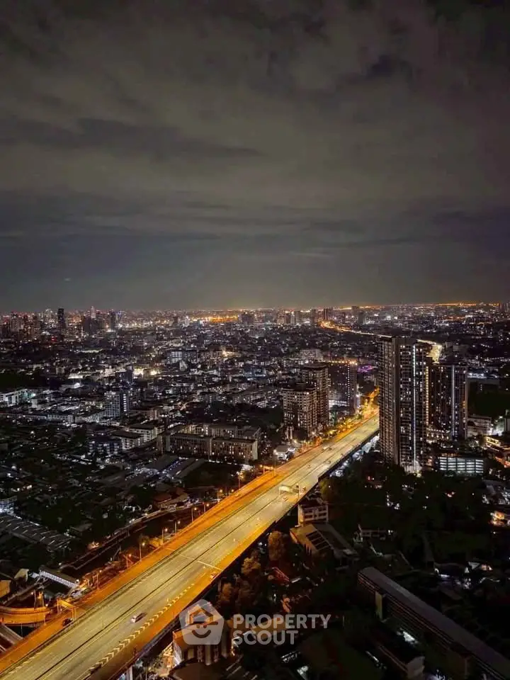 Stunning cityscape view with illuminated highway and skyline at night, showcasing urban living.