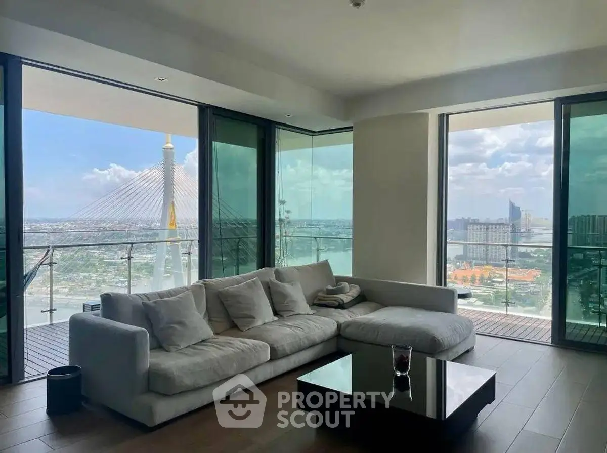 Luxurious living room with stunning city view and spacious balcony.