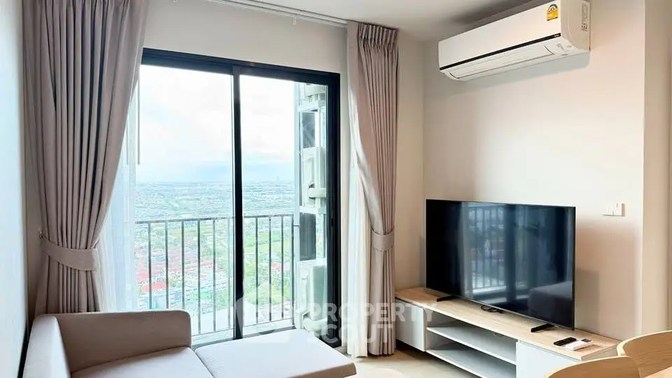 Modern living room with large window and city view, featuring sleek furniture and air conditioning.