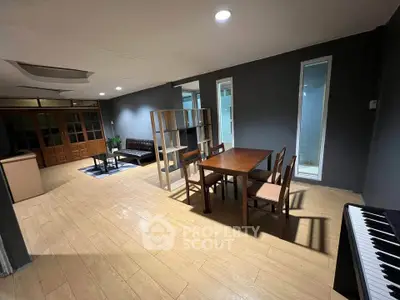 Spacious living room with modern furniture and open layout, perfect for entertaining guests.