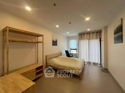 Spacious bedroom with modern furnishings and natural light