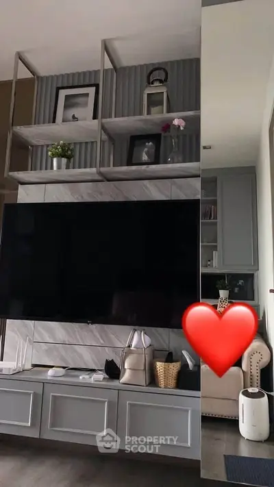 Stylish living room with modern shelving and large TV
