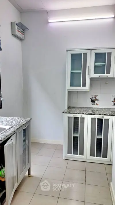 Modern kitchen with sleek cabinets and granite countertops, perfect for culinary enthusiasts.